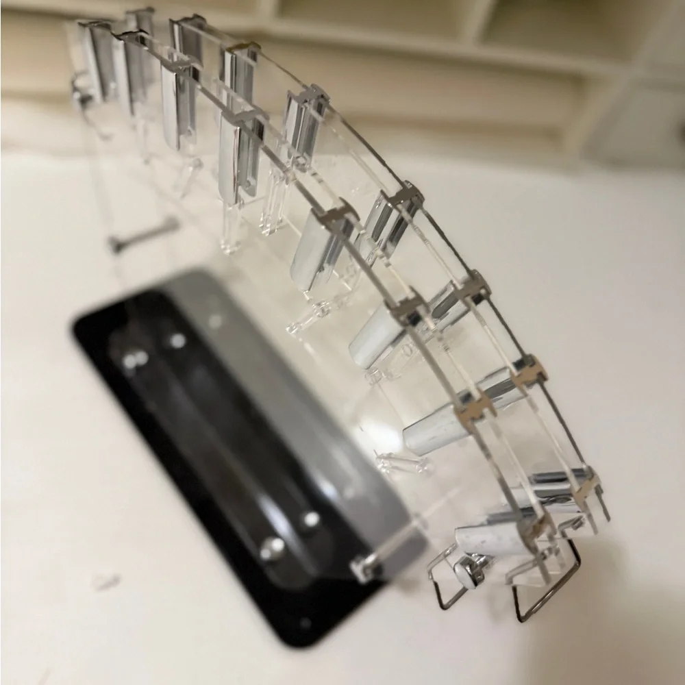 clear acrylic knife block or stand, designed to hold and display kitchen knives.